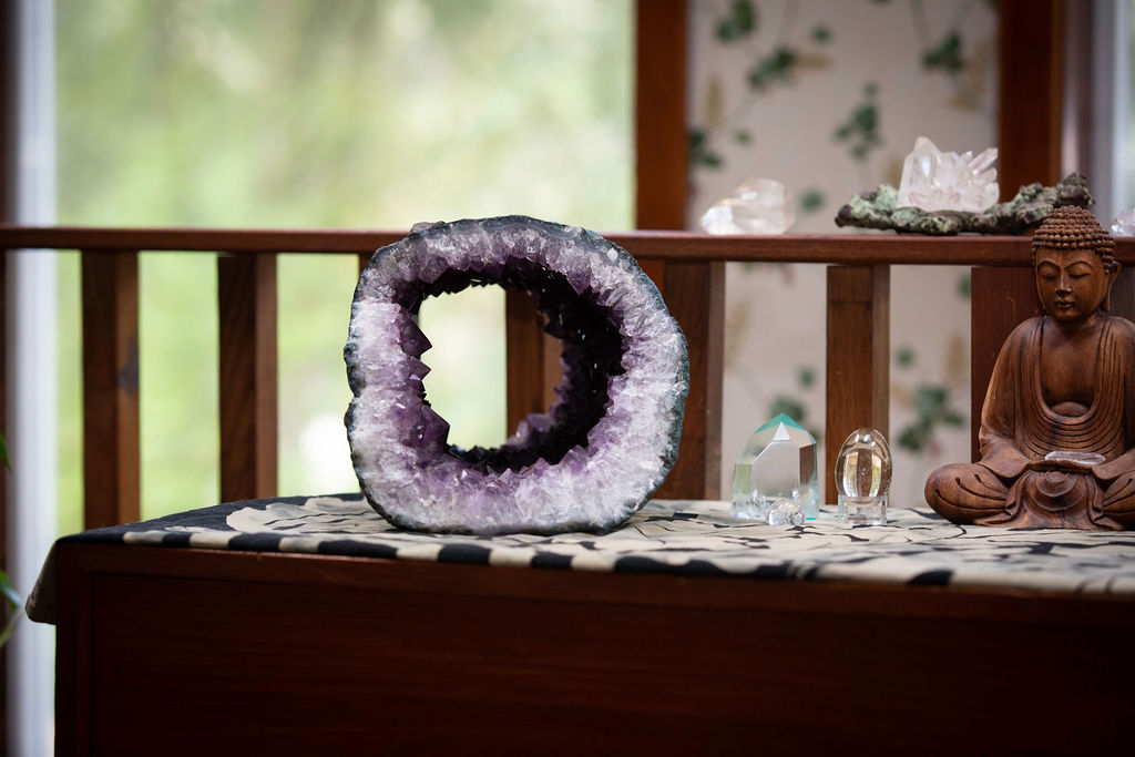 Amethyst Geode with other crystals on a table